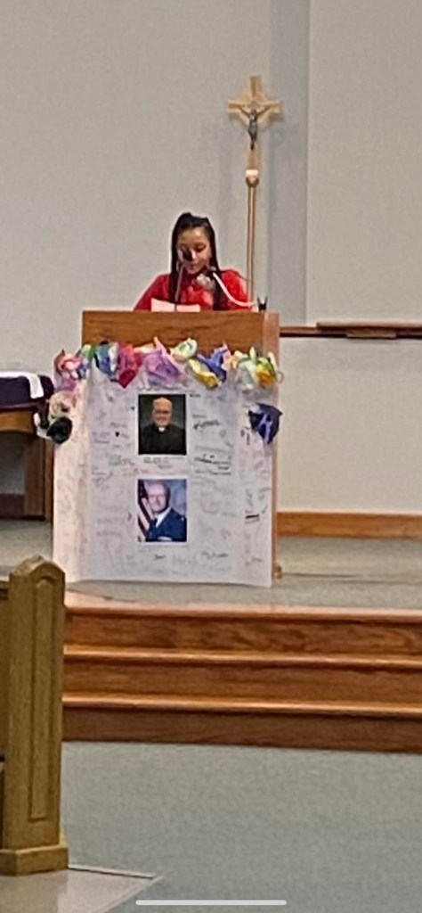 student at podium in church reading to church service